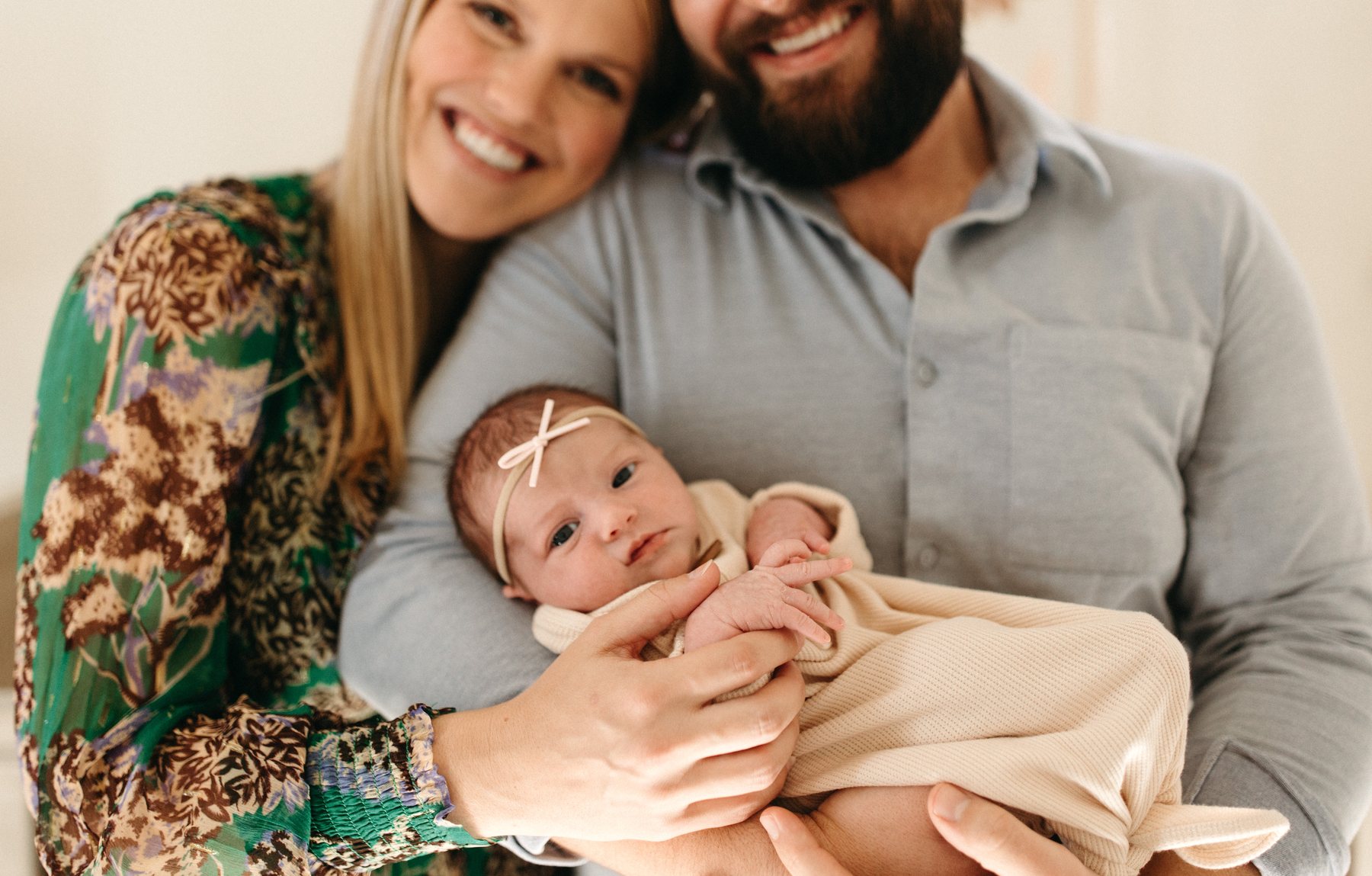A couple cradling their newborn — the enduring relationships at the heart of our work.